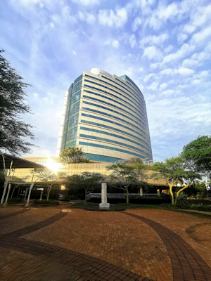 Finished steel frame building used as a modern office space surrounded by greenery.