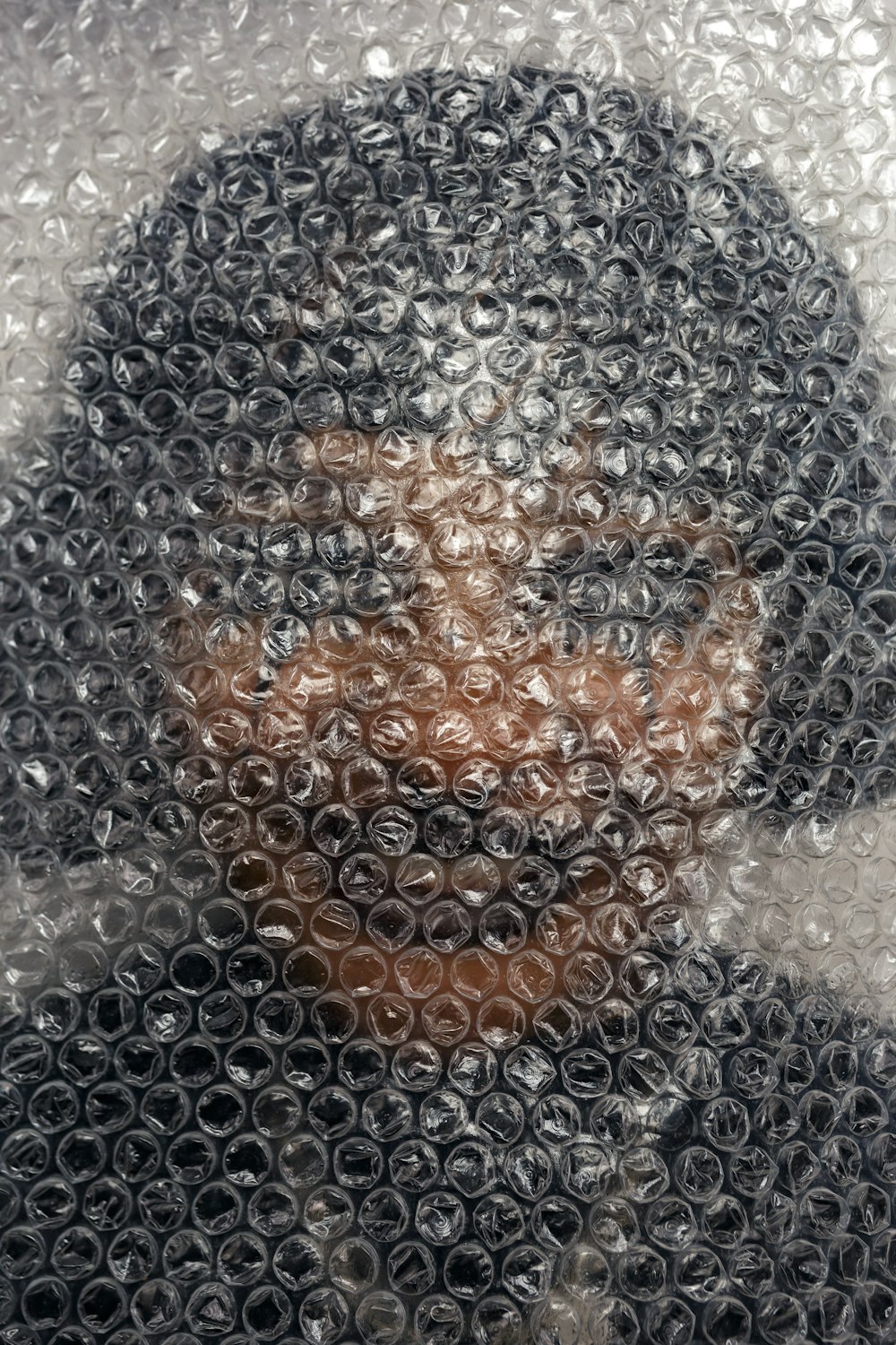 a close up of a person's face through a bubble
