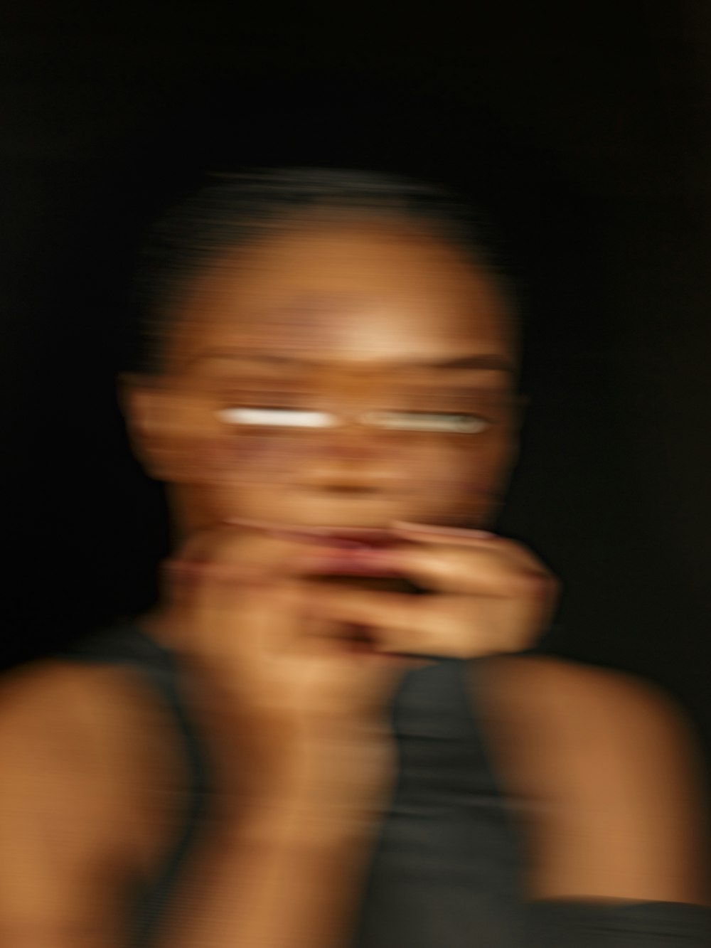 a blurry photo of a woman holding a doughnut