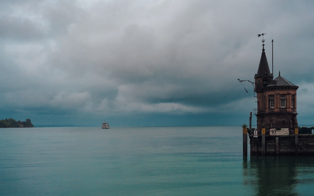 a boat is out on the water under a cloudy sky