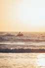 a person riding a surfboard on top of a wave