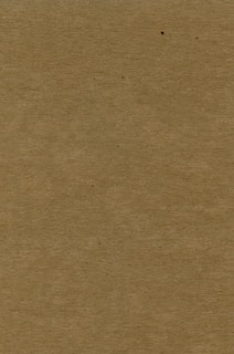 a brown piece of cardboard with a black dot on it