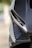 Close-up of an angular car headlight on a modern vehicle featuring sleek lines and carbon fiber detailing.