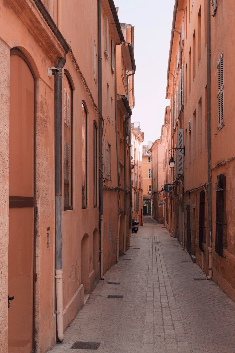 a narrow city street lined with tall buildings