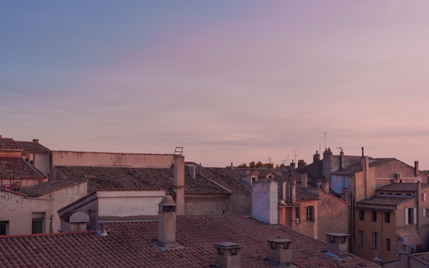 Evening shot of a tile roof glowing warmly under soft outdoor lighting.