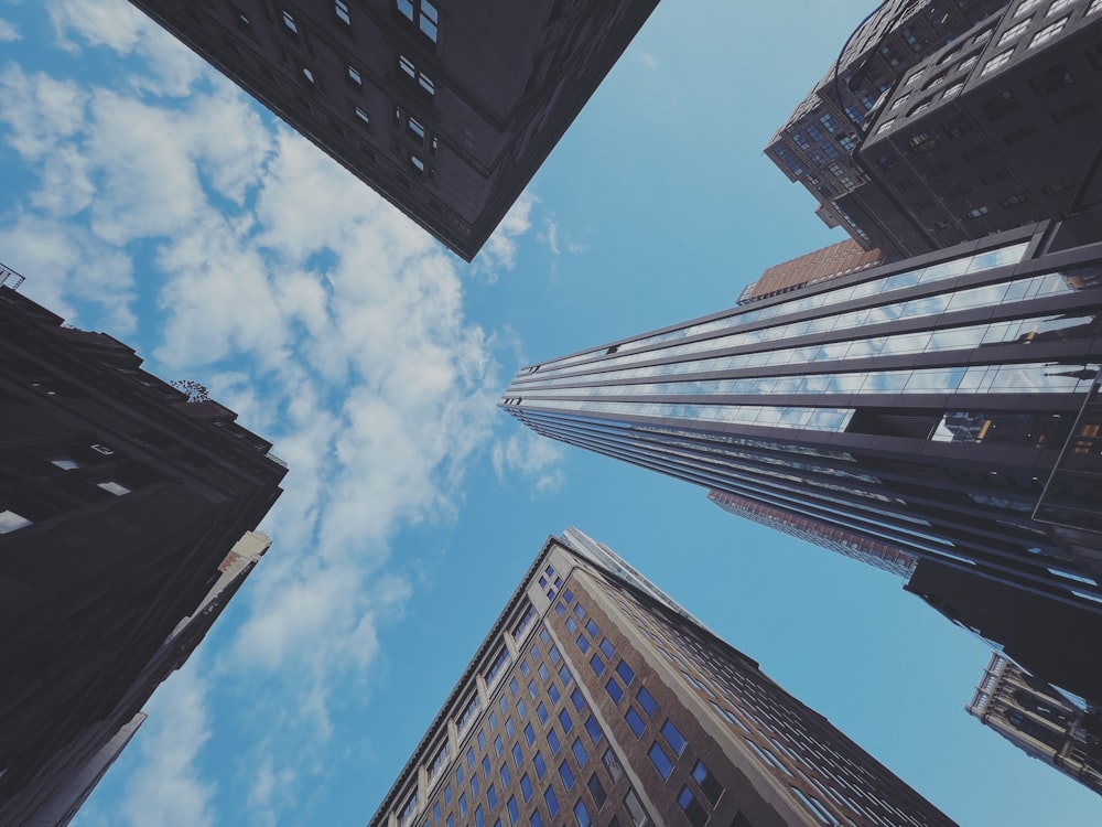 looking up at tall buildings in a city