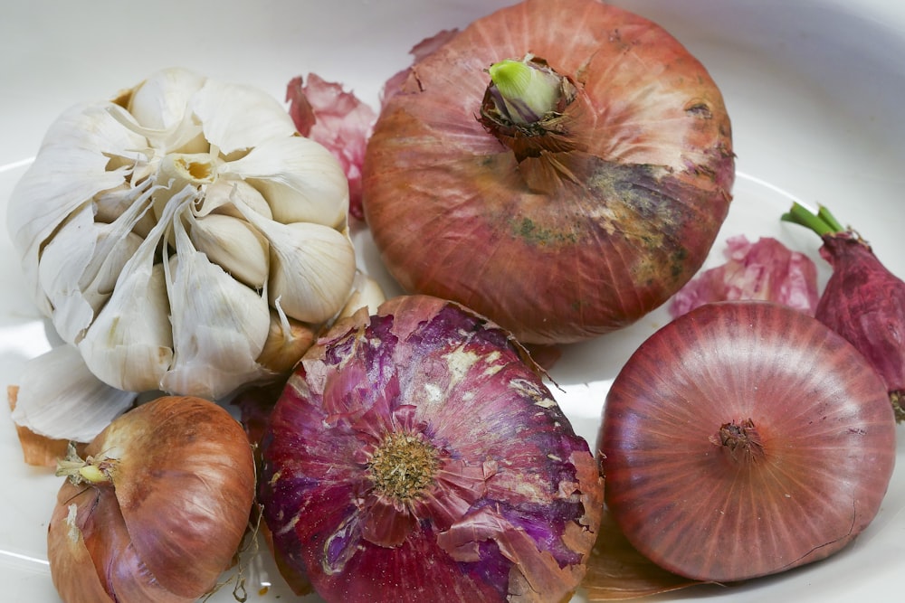 a white plate topped with onions and garlic