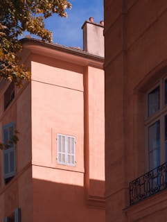 Stucco exterior wall with a textured finish glowing warmly in the afternoon sun.