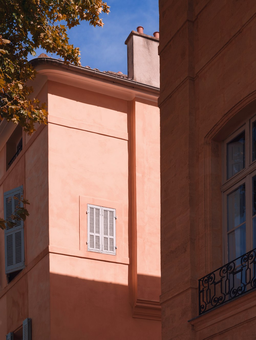 a tall building with a window and a balcony