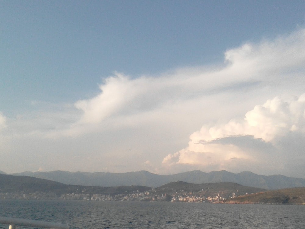 a large body of water with mountains in the background