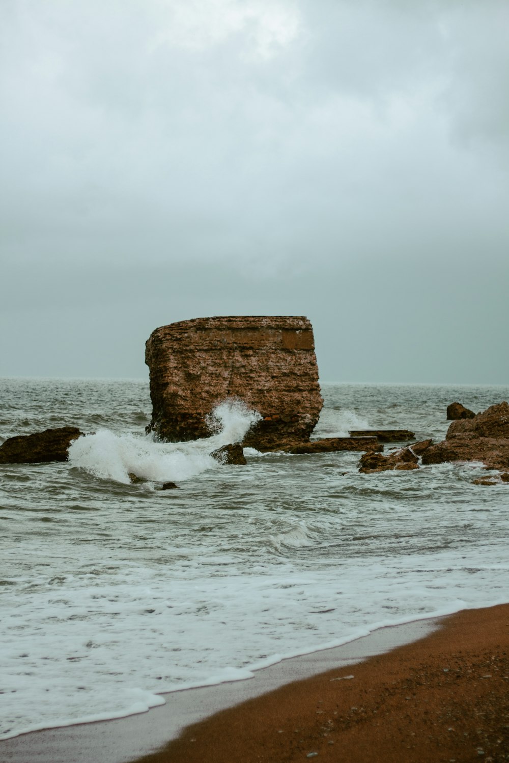 a rock outcropping in the middle of the ocean