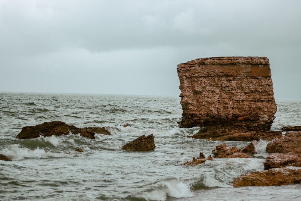 a rock outcropping in the middle of the ocean