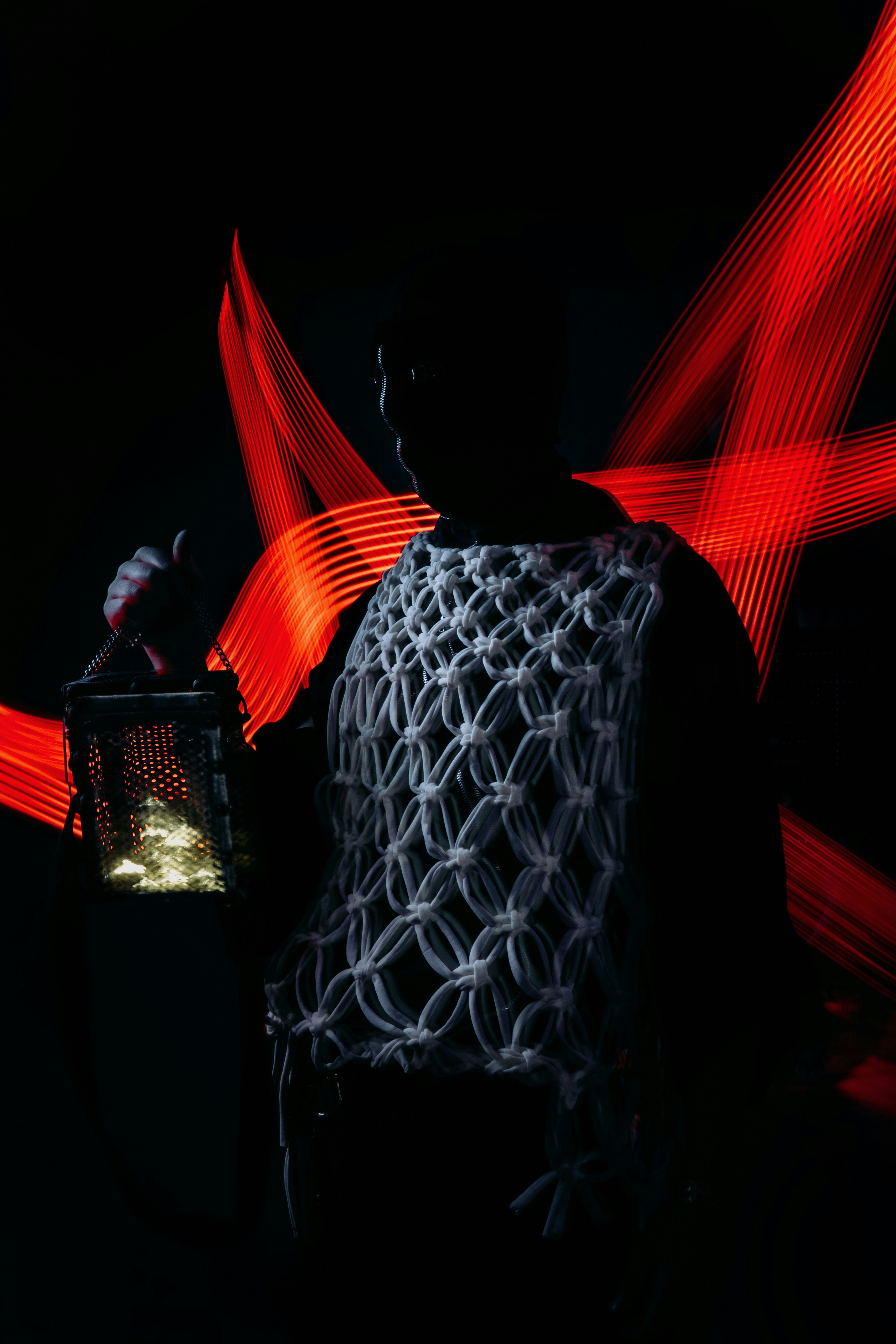 a man holding a lantern in the dark