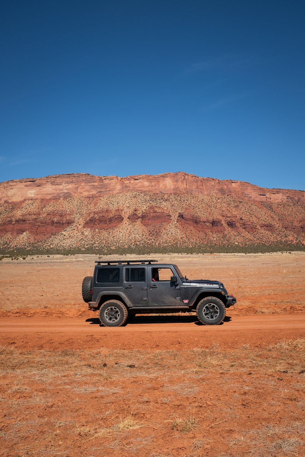 Ein Jeep parkt mitten in der Wüste