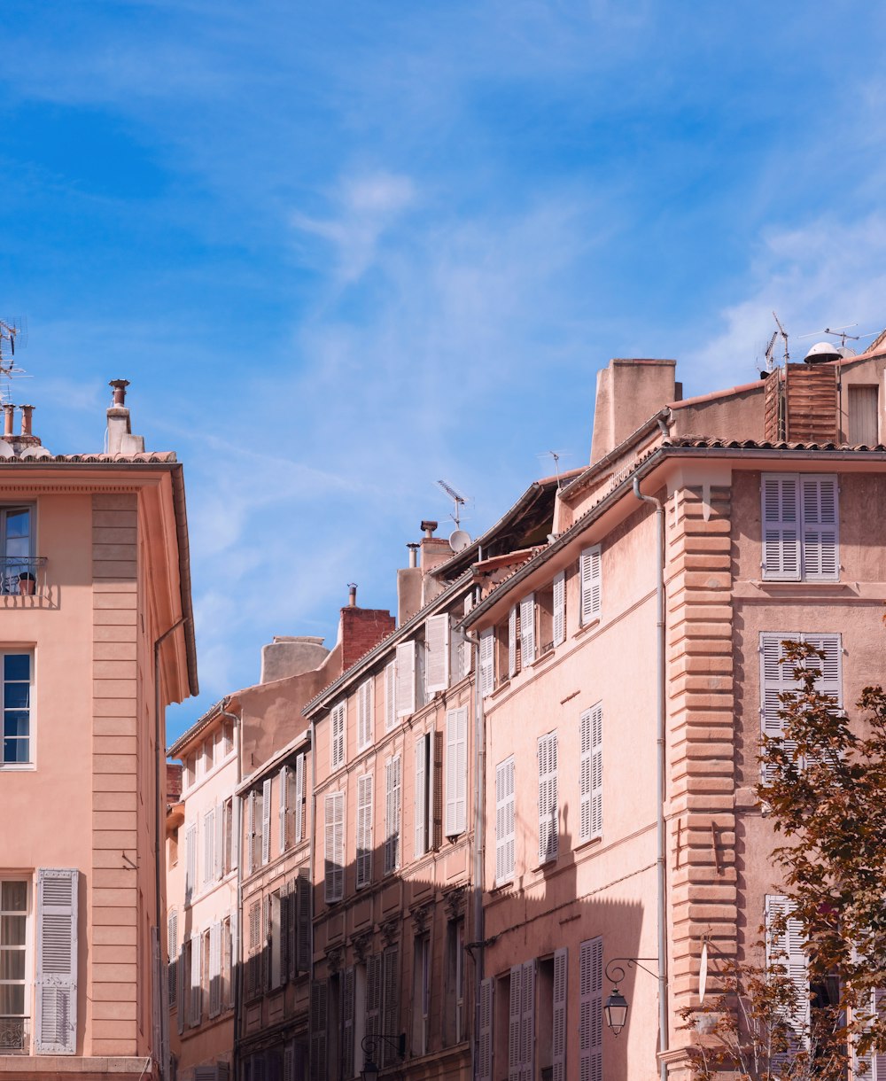 a row of buildings with a blue sky in the background