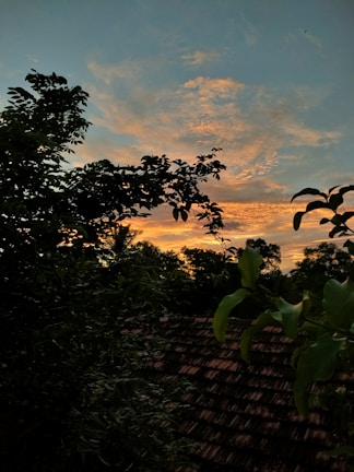 A colorful sunset casting warm hues over the rustic cabins nestled in Zacatlán's hills
