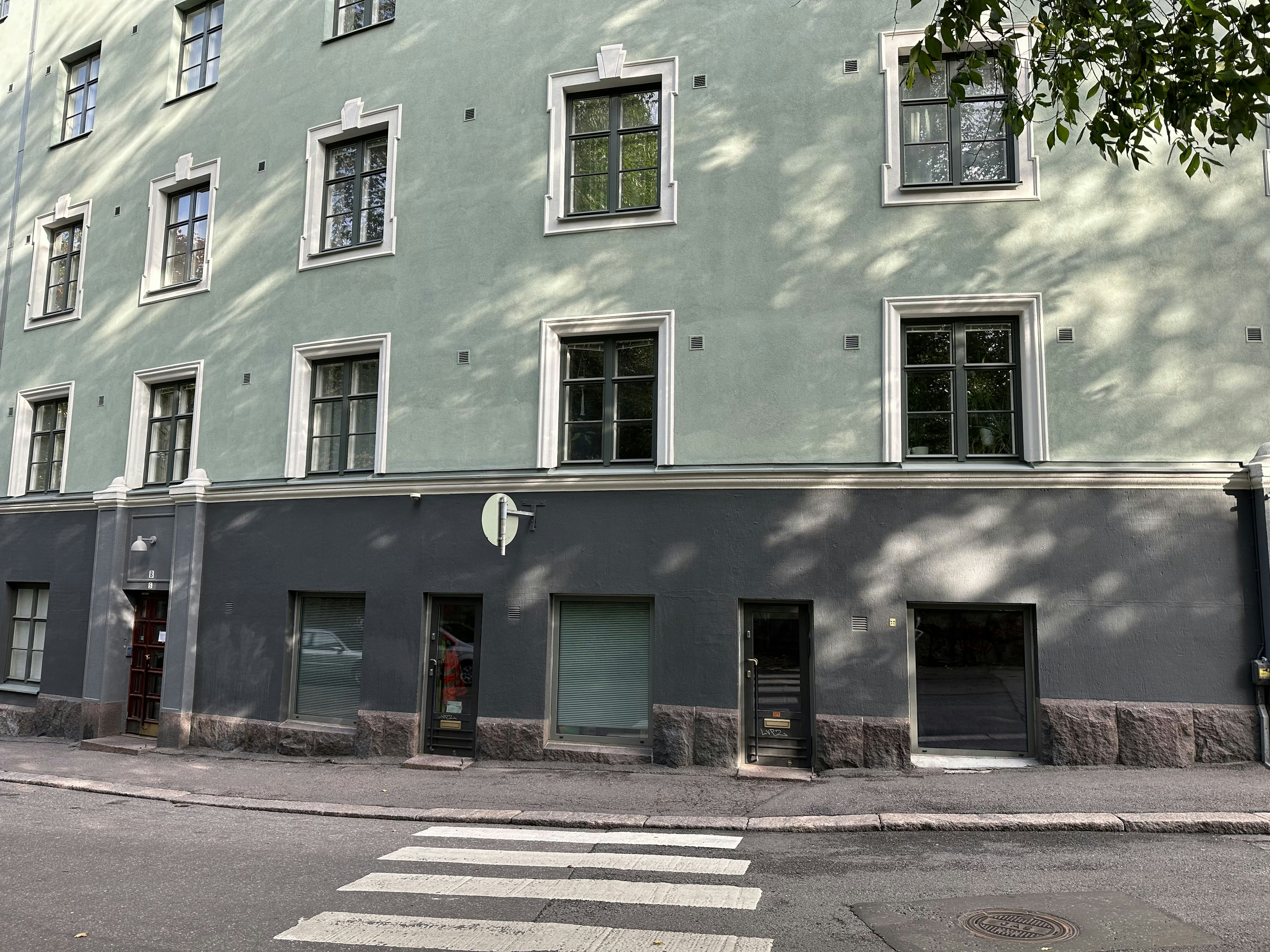 a street corner with a building and a crosswalk