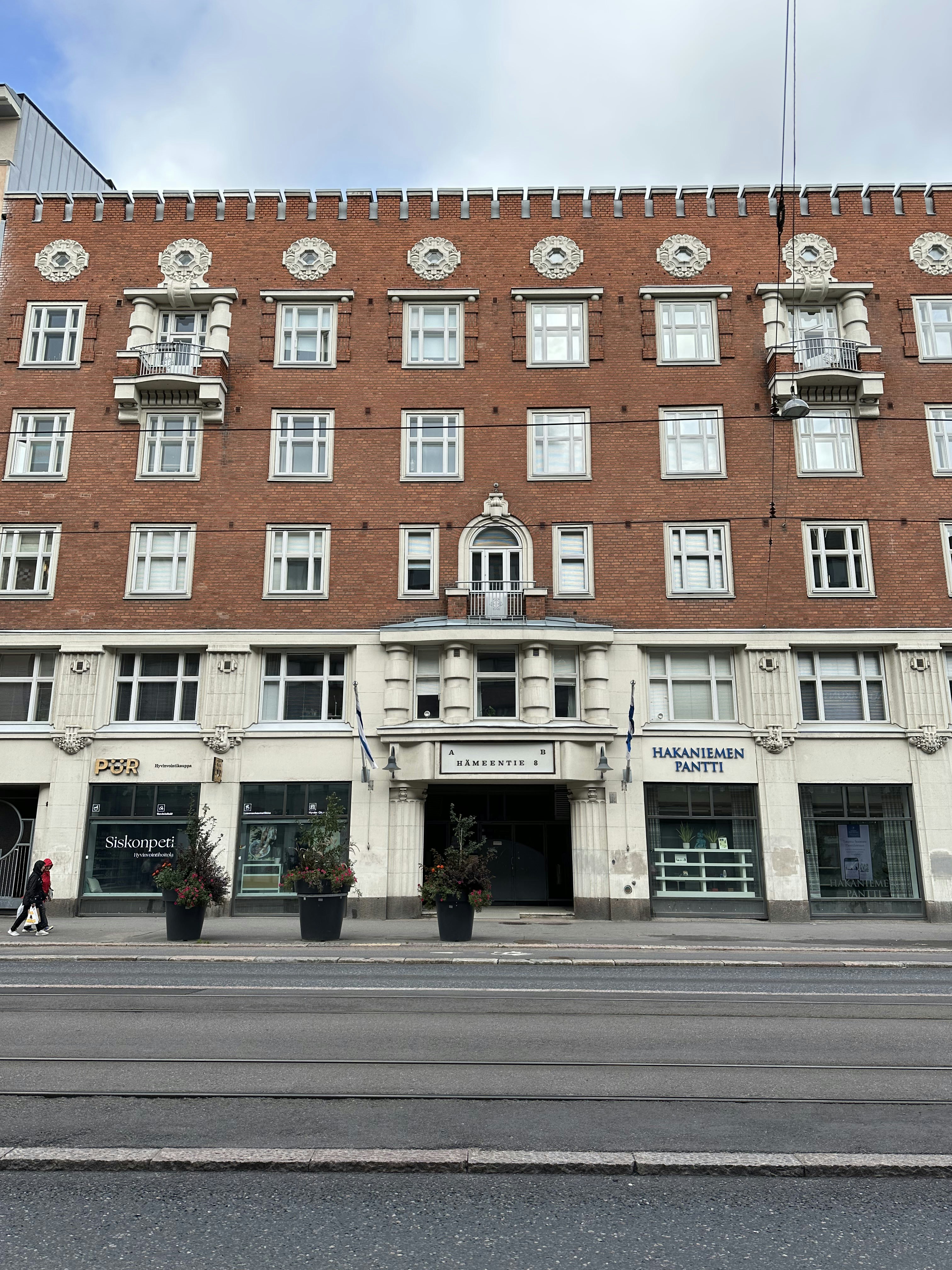 a tall brick building with many windows on the front of it