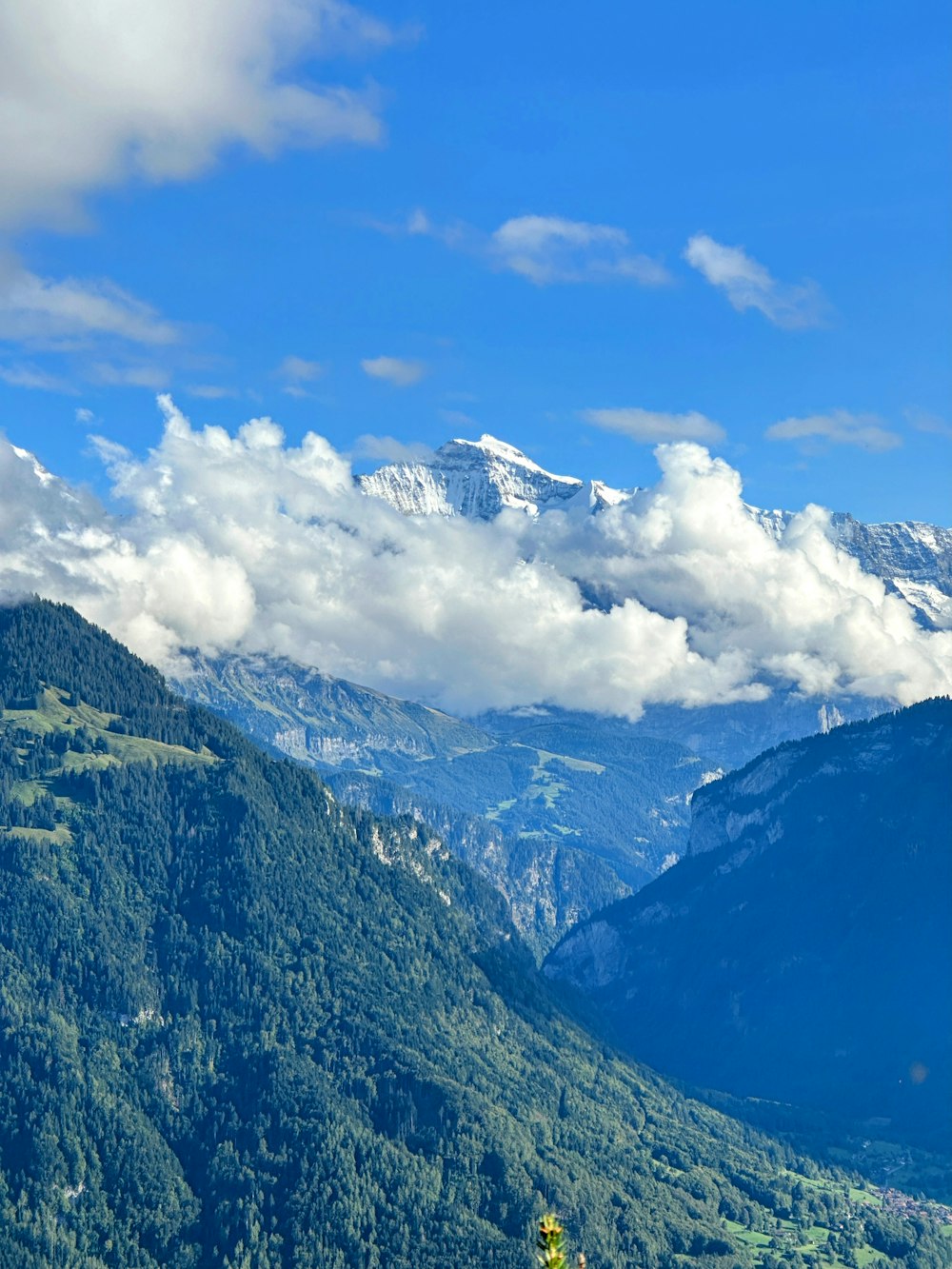 a scenic view of a mountain range with clouds in the sky