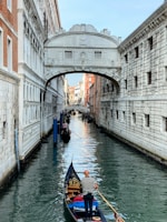 Traveler enjoying a serene gondola ride on the canals of Venice.