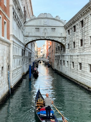 Traveler enjoying a serene gondola ride on the canals of Venice.