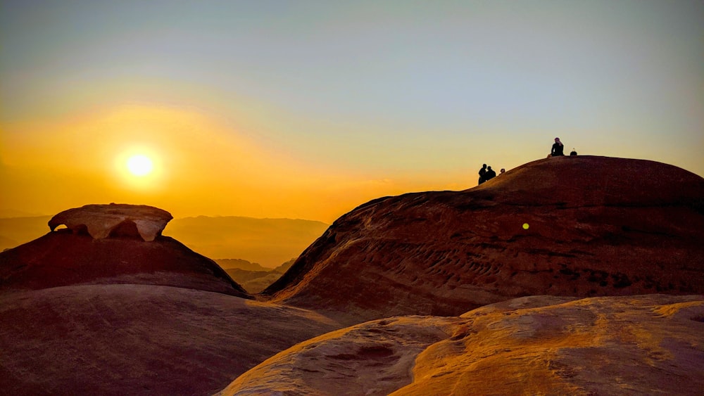 a couple of people standing on top of a mountain