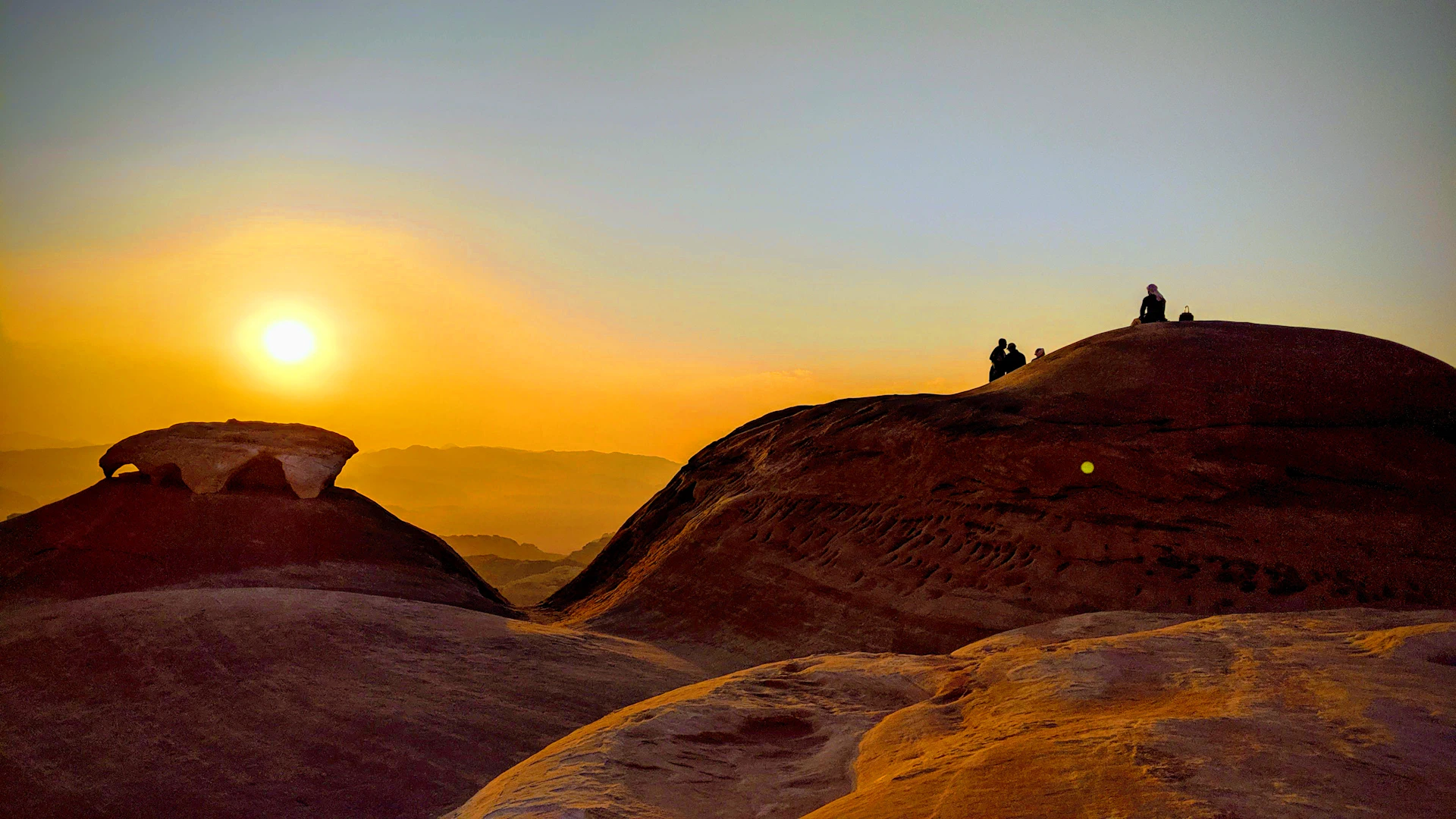 a couple of people standing on top of a mountain