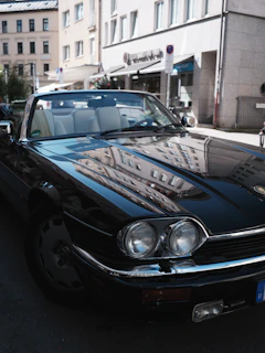 A shiny Enfield car parked by a scenic city street, ready for a comfortable ride.