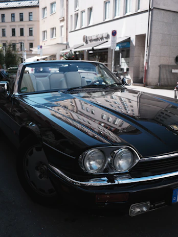 A shiny Enfield car parked by a scenic city street, ready for a comfortable ride.