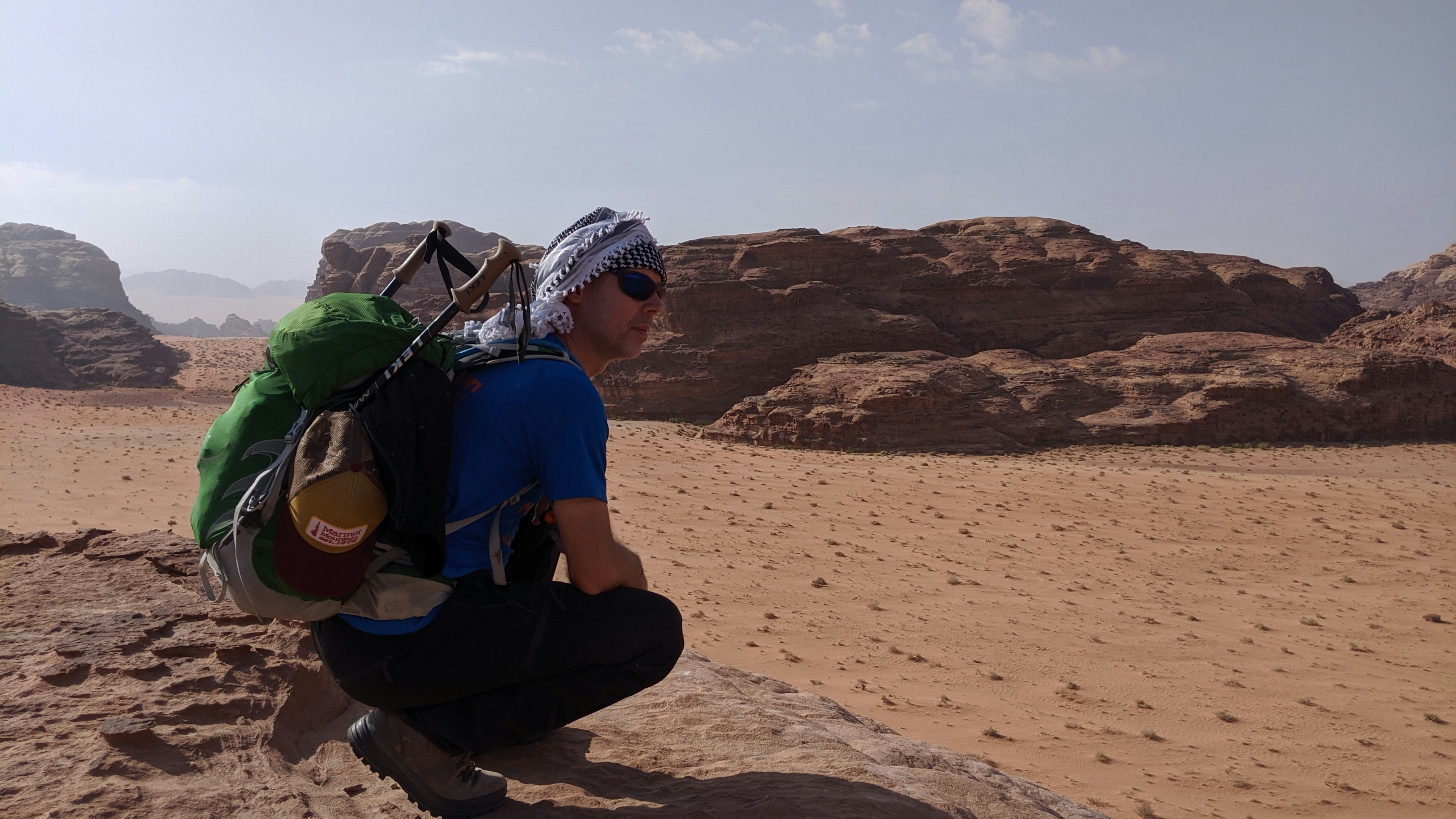 a man sitting on a rock in the desert