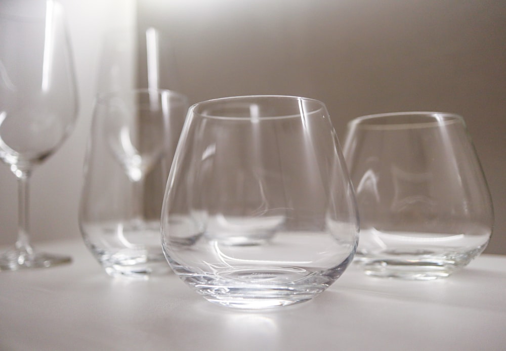 a group of wine glasses sitting on top of a table