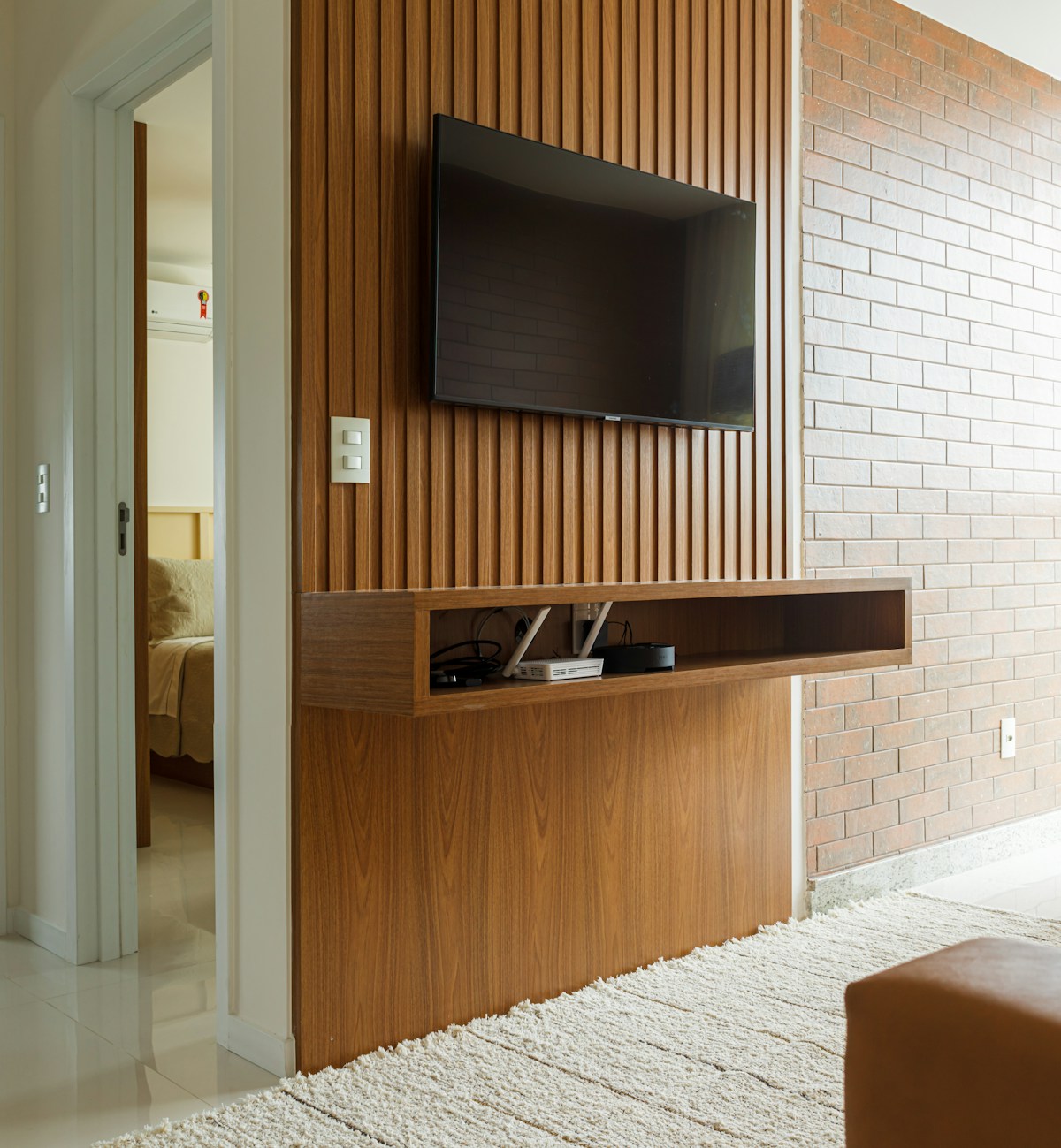 A flat screen tv mounted on a wooden wall