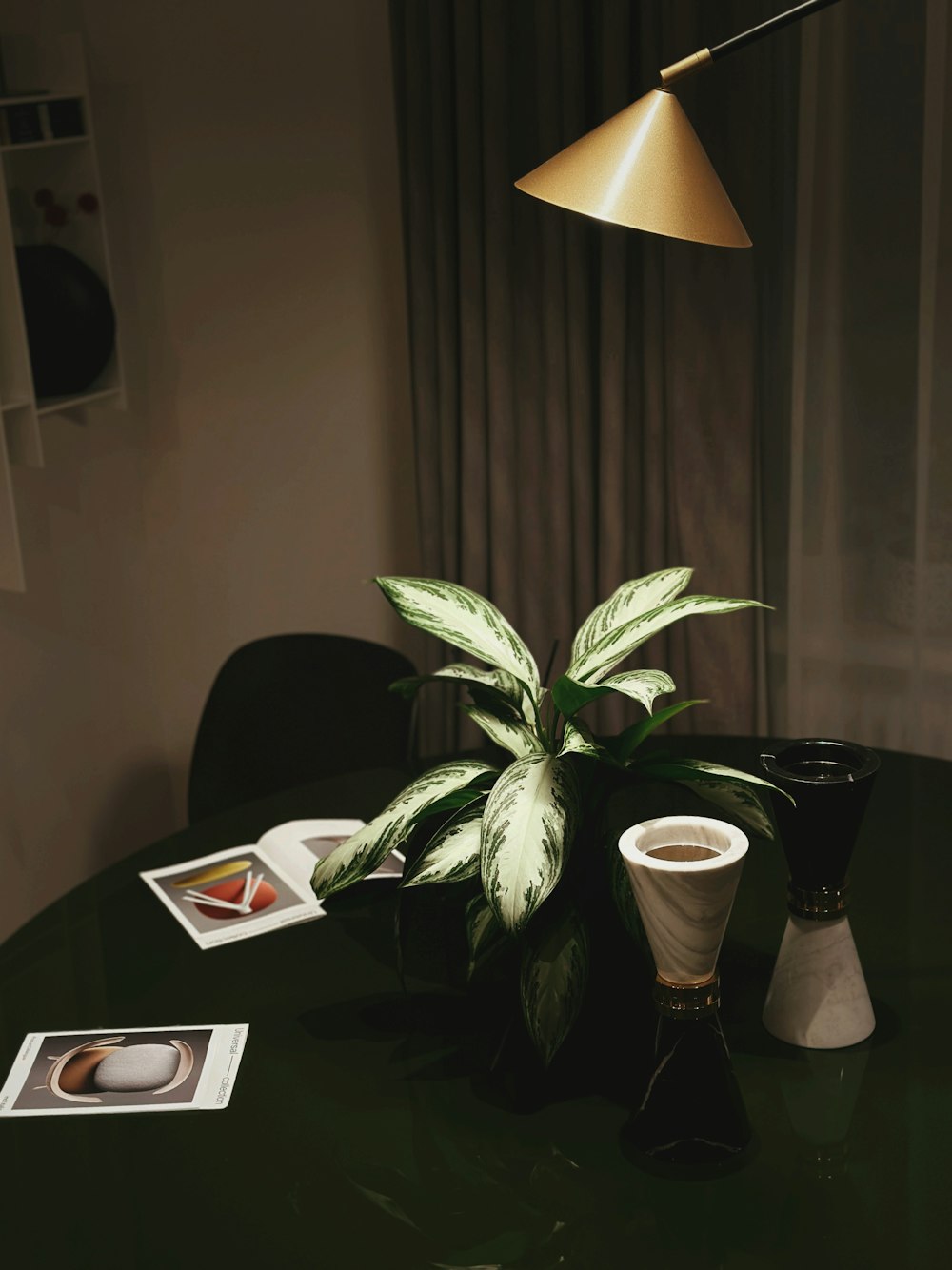 a green table topped with a potted plant