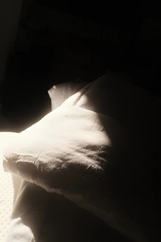 Close-up of a handcrafted autograph pillow glowing softly in warm light
