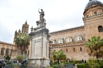 a statue in front of a large building