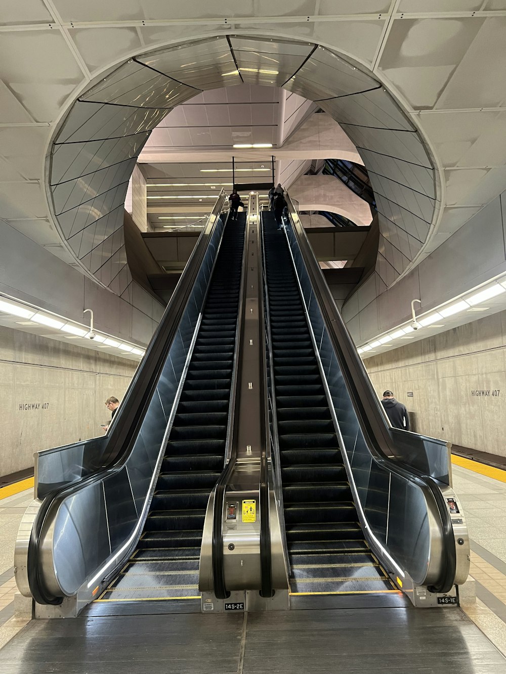 an escalator in a subway station with people on it