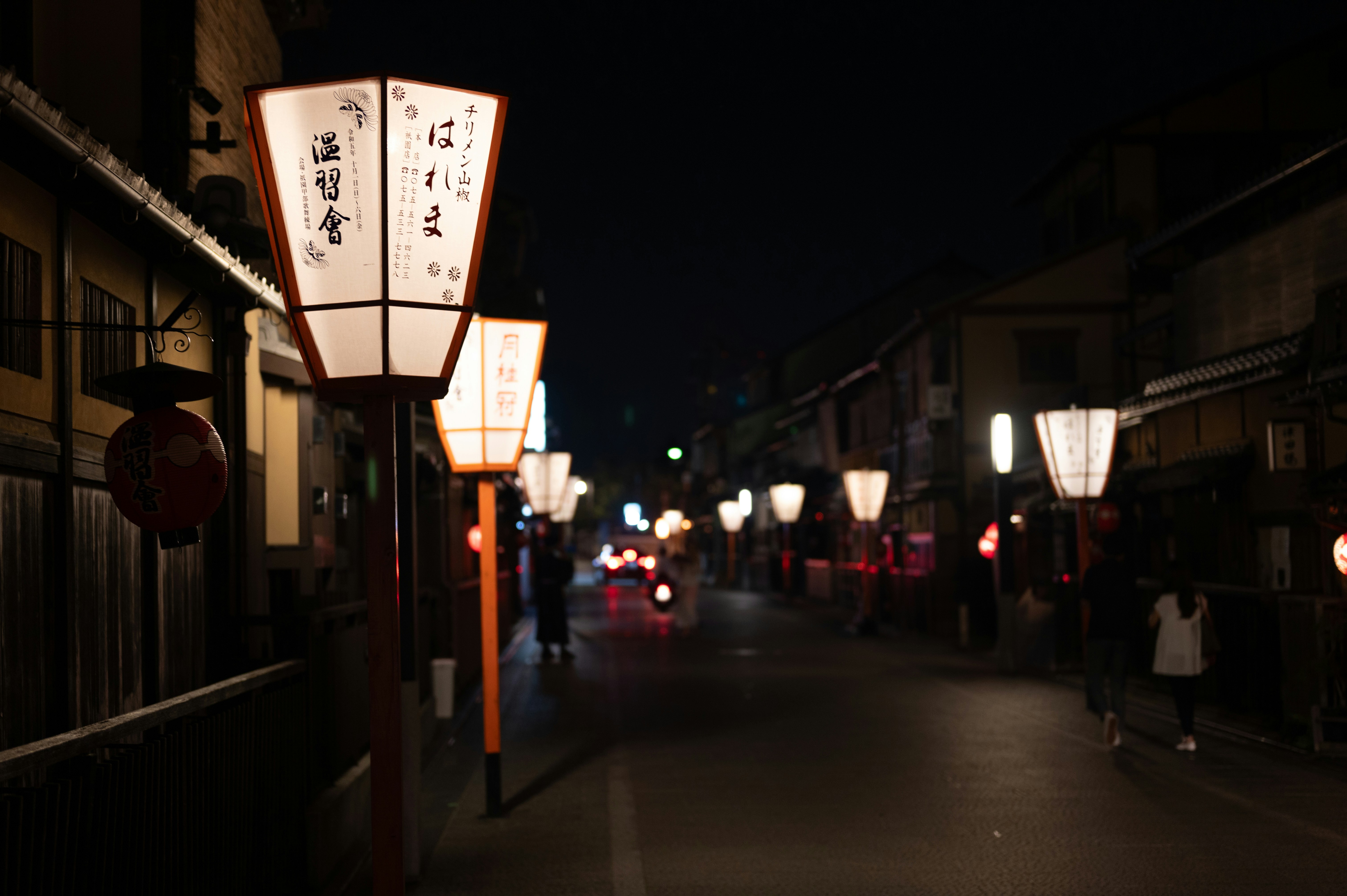 a street at night with lanterns lit up