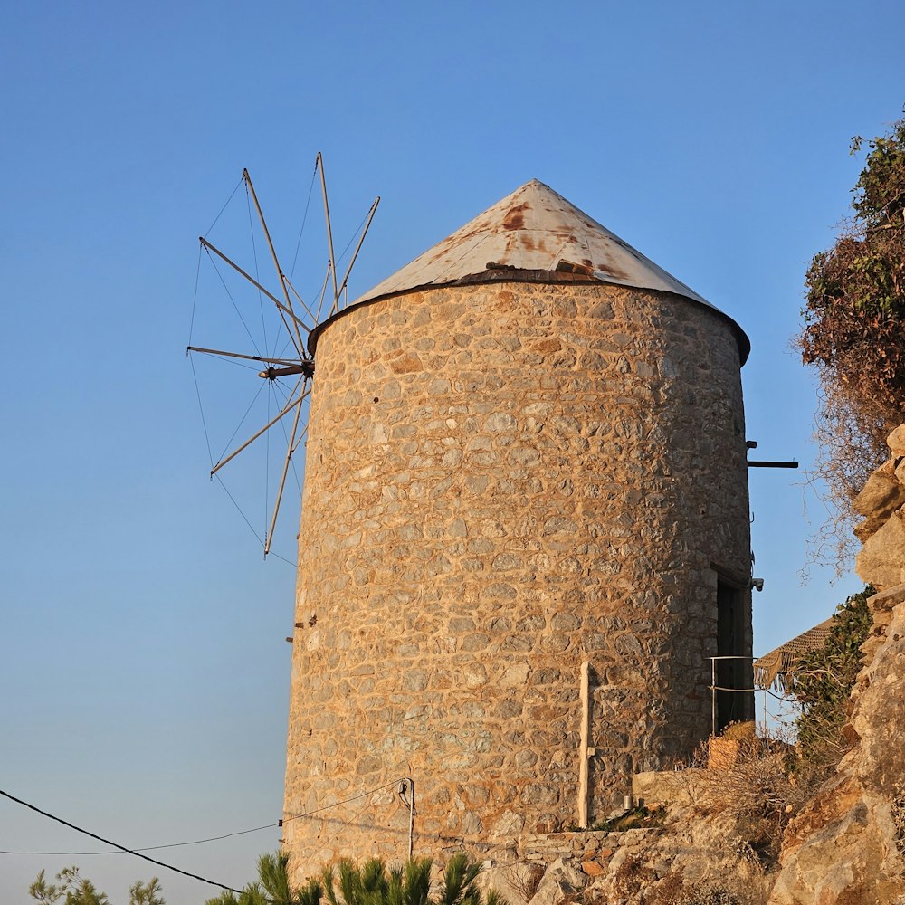 a stone building with a windmill on top of it