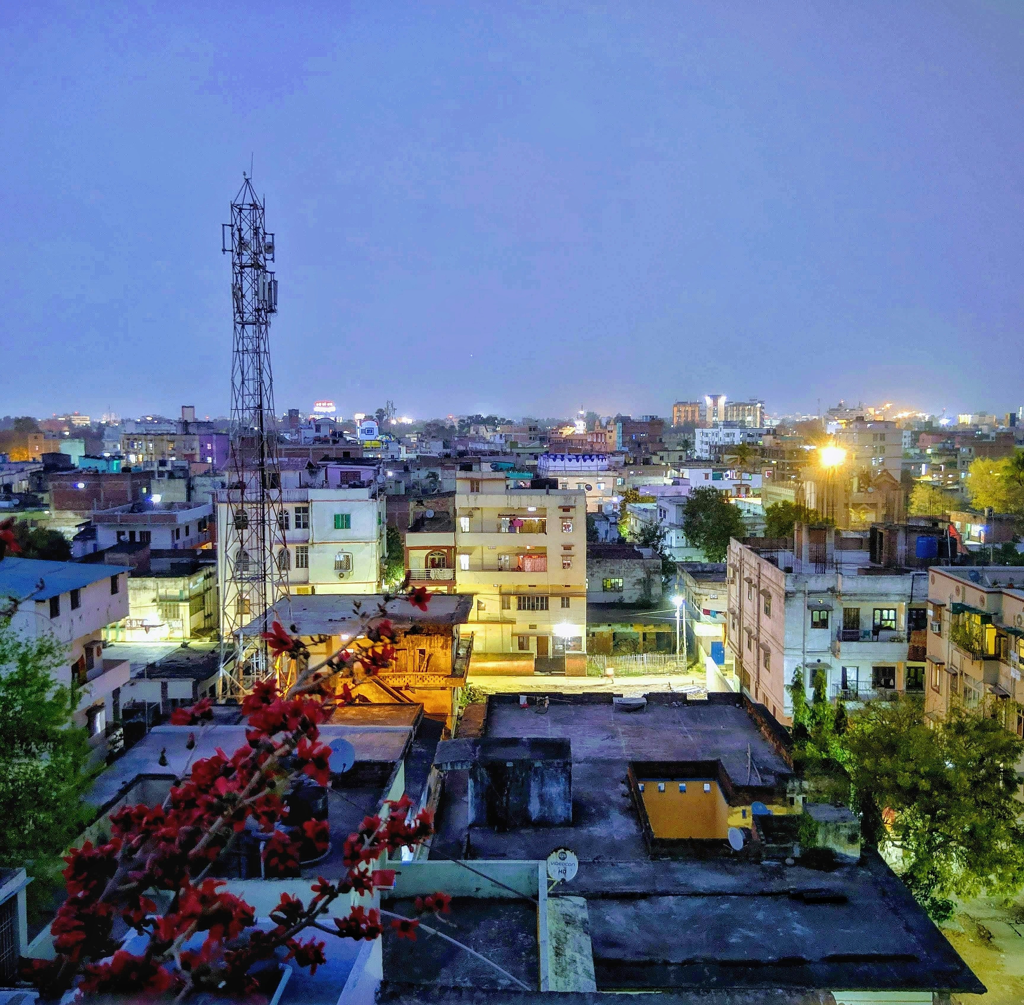 A view of a city at night from a rooftop photo – Free Night Image on ...