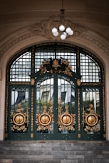 a large green door with gold decorations on it