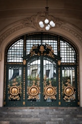 a large green door with gold decorations on it