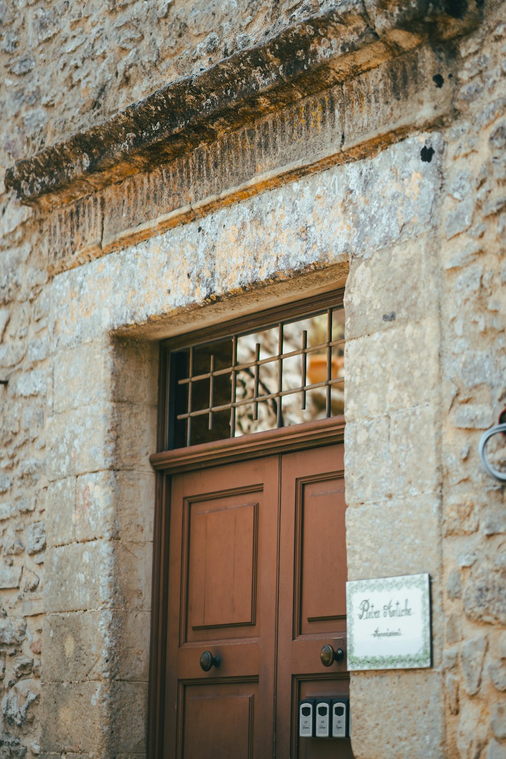 a brown door with a sign on the side of it