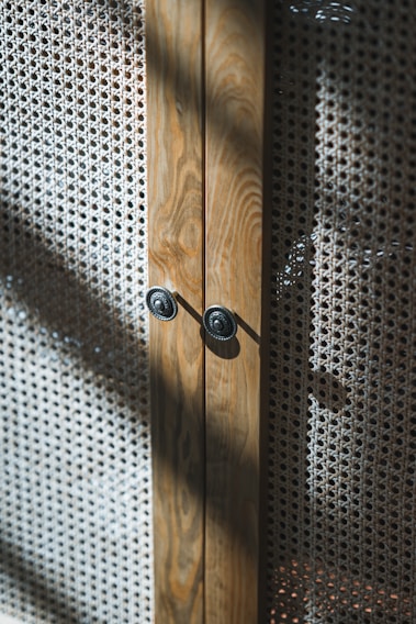 Close-up of a finely crafted wooden cabinet with intricate grain patterns and smooth finish.