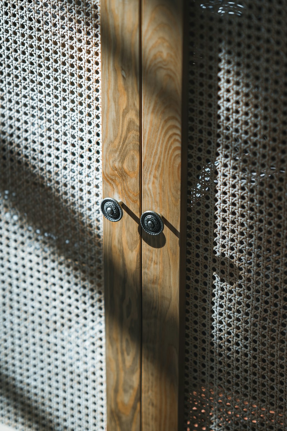 a close up of a wooden door with metal handles