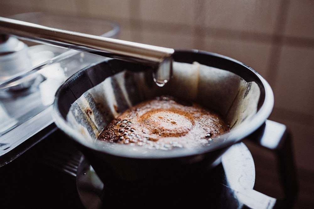 a frying pan filled with liquid on top of a stove