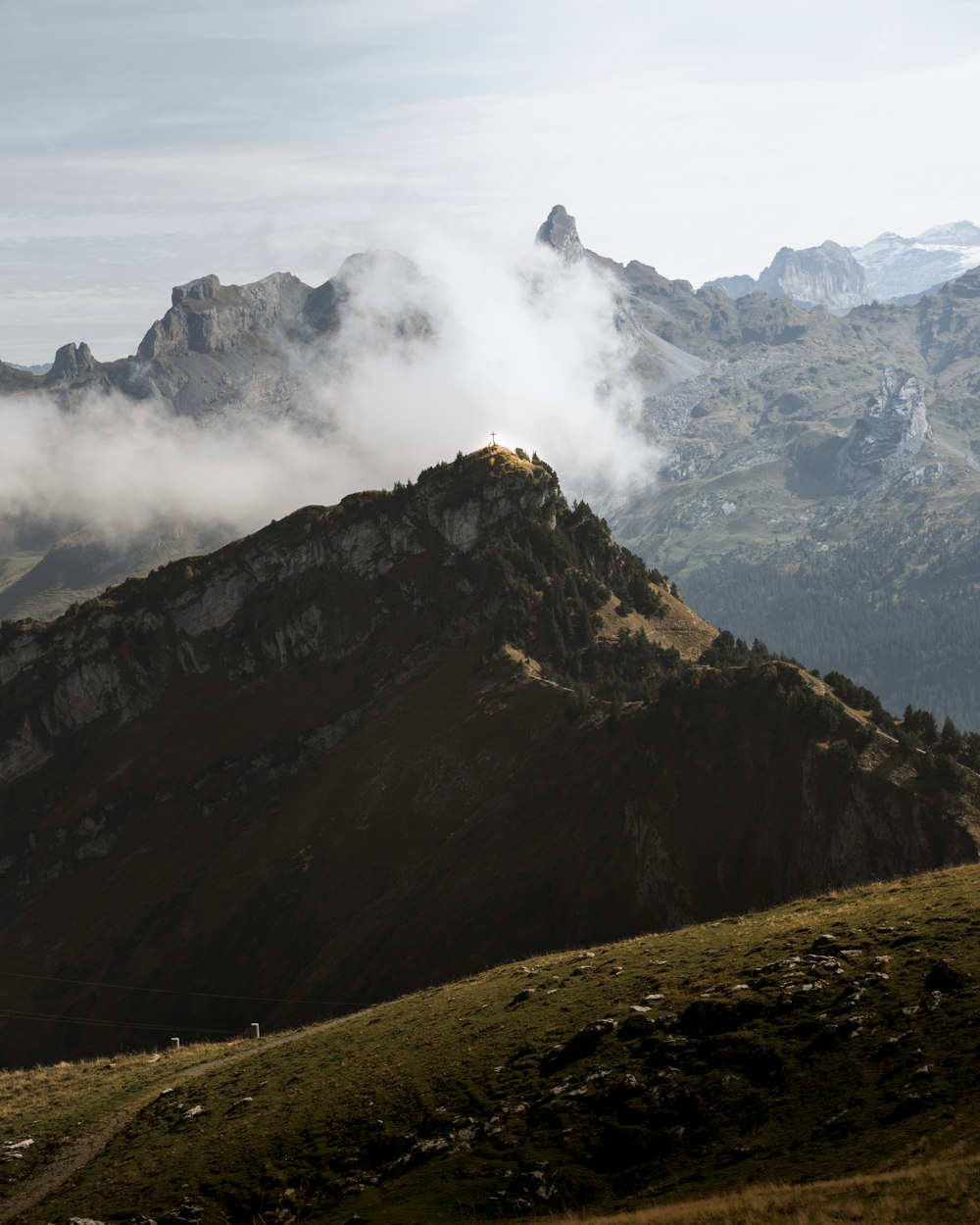 a view of a mountain range with a few clouds in the sky