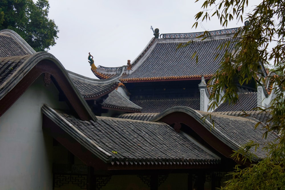 the roof of a building with a tree in front of it