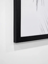 Close-up of high-resolution framed artwork hanging on a clean white gallery wall.