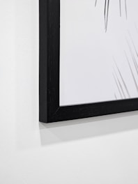 A close-up of a beautifully framed abstract painting.