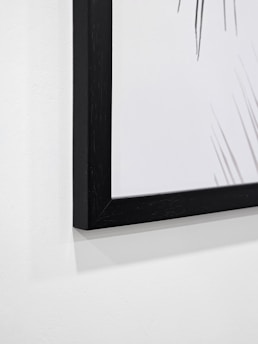 A close-up of a beautifully framed abstract painting.
